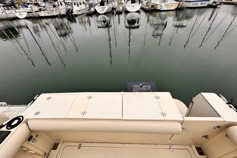 Slide: The Image of 2003 Albin 28 TE boat stern view at marina with docked boats. - 11