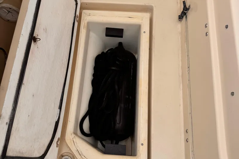Slide: The Image of Storage compartment on a 2003 Albin 28 TE boat with coiled rope inside. - 14