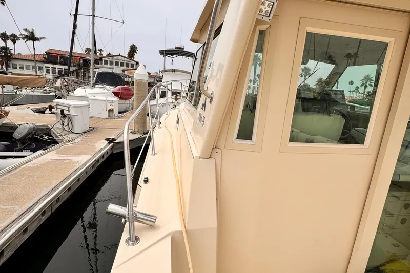 Slide: The Image of 2003 Albin 28 TE docked at marina with palm trees in background. - 15