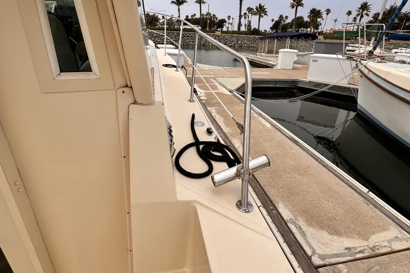 Slide: The Image of 2003 Albin 28 TE boat docked at marina with palm trees in background. - 16