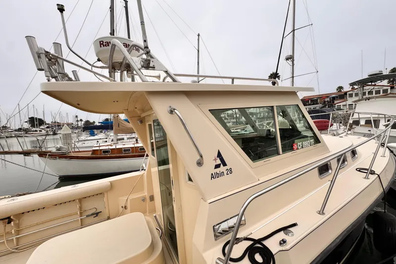 Slide: The Image of 2003 Albin 28 TE boat docked in a marina, showcasing its sleek design and structure. - 17