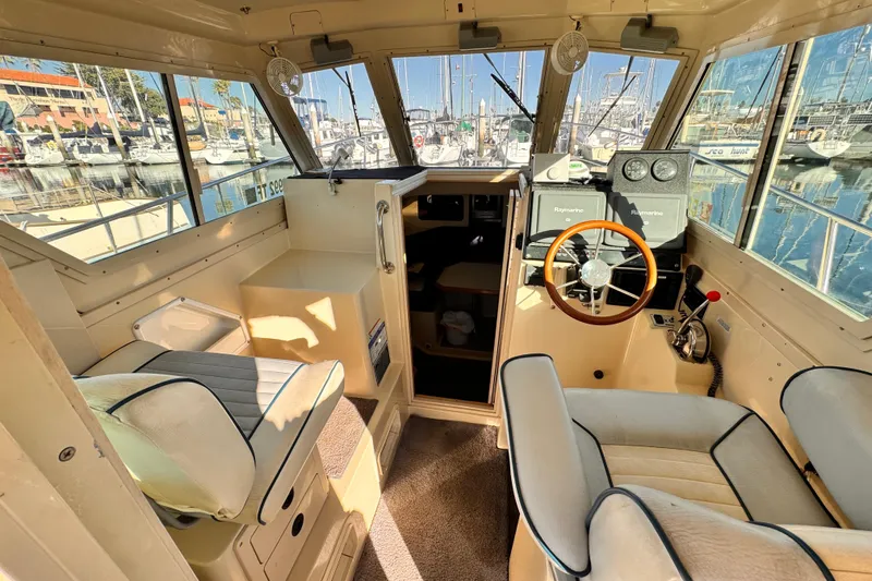 Slide: The Image of Interior of a 2003 Albin 28 TE boat with steering wheel and seating. - 18