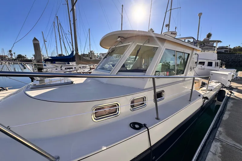 Slide: The Image of 2003 Albin 28 TE boat docked in a sunny marina setting. - 3