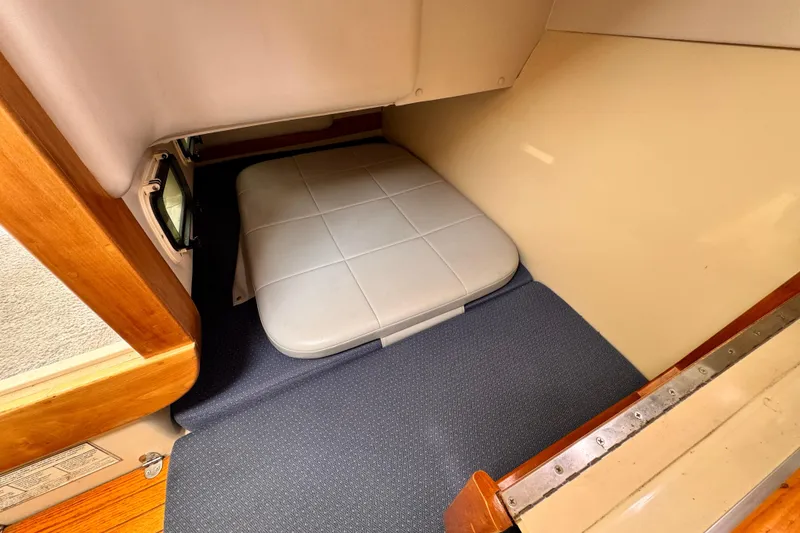Slide: The Image of 2003 Albin 28 TE cabin interior with cushioned seating and wooden accents. - 32
