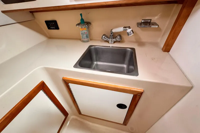 Slide: The Image of 2003 Albin 28 TE boat interior with sink and storage cabinet. - 34