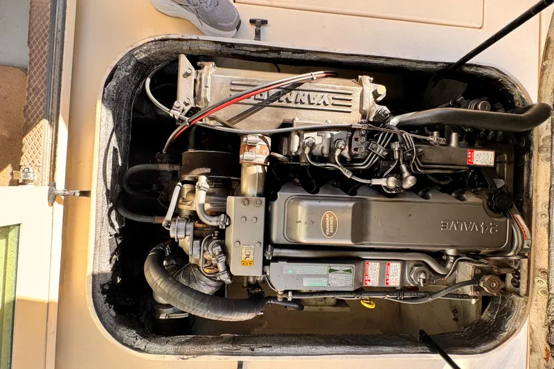 Slide: The Image of Engine compartment of a 2003 Albin 28 TE boat, featuring a Yanmar diesel engine. - 35