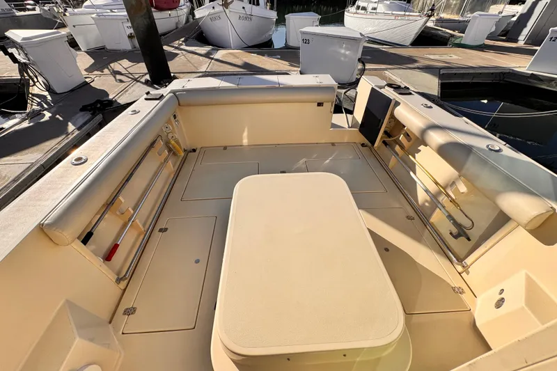 Slide: The Image of 2003 Albin 28 TE boat interior with seating and storage at a marina. - 45