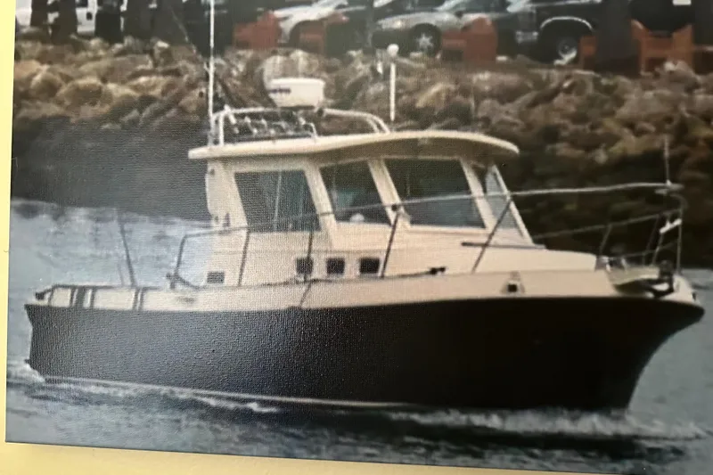 Slide: The Image of 2003 Albin 28 TE boat cruising near rocky shoreline. - 46