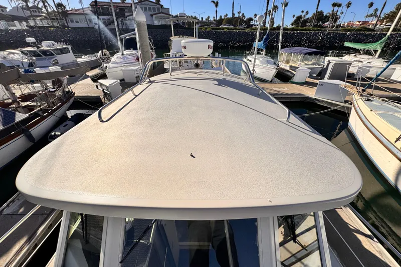 Slide: The Image of 2003 Albin 28 TE boat docked in a marina, surrounded by other vessels. - 5