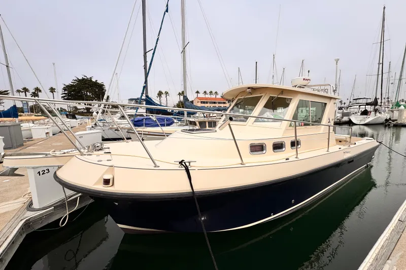 Slide: The Image of 2003 Albin 28 TE boat docked in marina, surrounded by sailboats. - 7