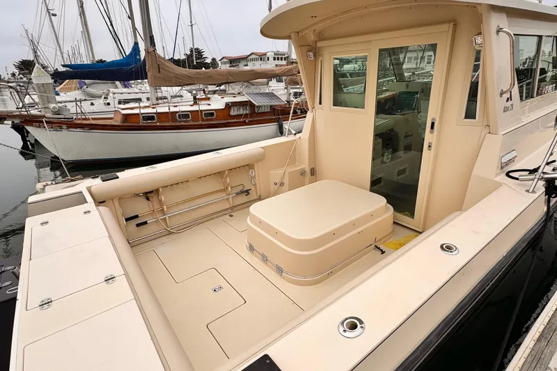 Slide: The Image of 2003 Albin 28 TE boat with spacious deck and sliding cabin door, docked at marina. - 8