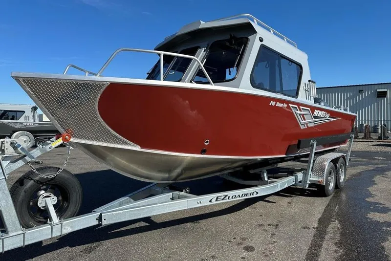 The Image of 2025 Hewescraft 240 Ocean Pro ET HT boat on trailer, red and silver design. - 0