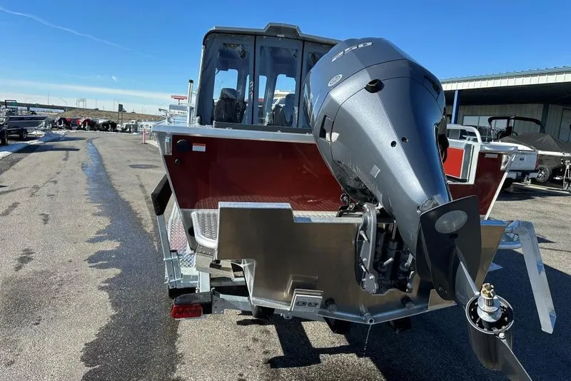 Slide: The Image of 2025 Hewescraft 240 Ocean Pro ET HT boat with powerful outboard motor, parked outdoors. - 3