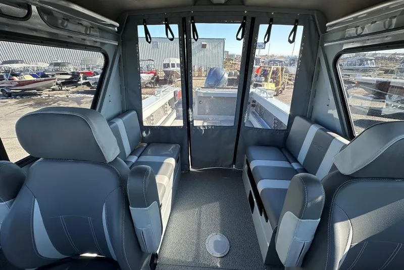 Slide: The Image of Interior of 2025 Hewescraft 240 Ocean Pro ET HT boat with gray seating and windows. - 7