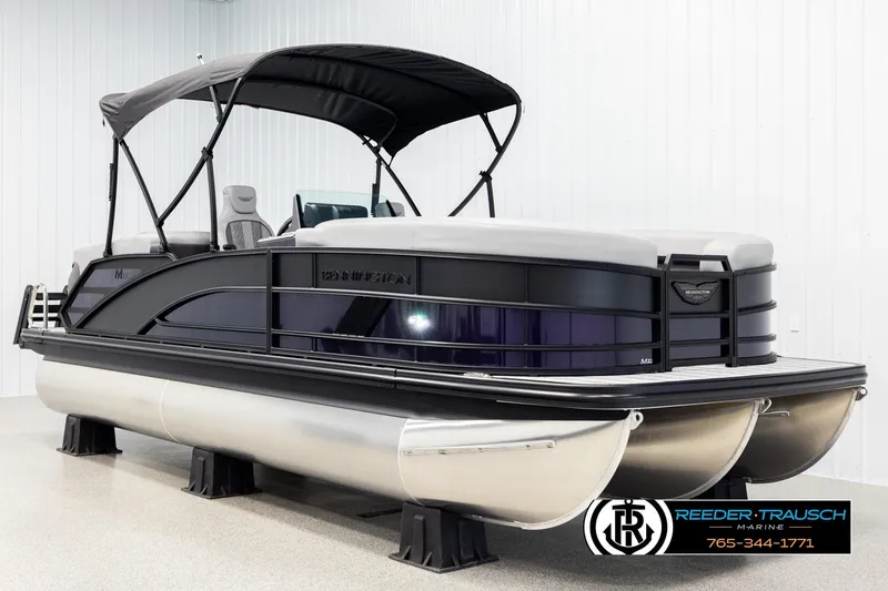 Slide: The Image of 2026 Bennington 22 MFBSE pontoon boat with canopy in showroom. - 3
