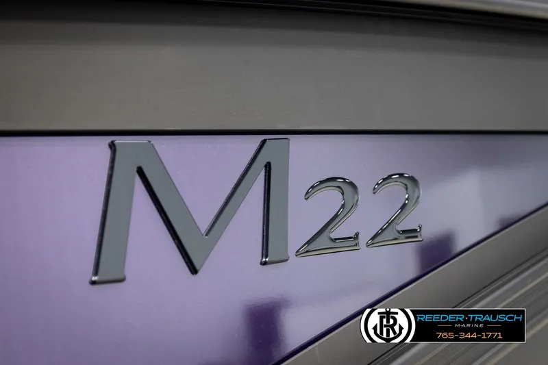 Slide: The Image of 2026 Bennington 22 MFBSE boat with sleek purple and black design, Reeder-Trausch Marine logo. - 46
