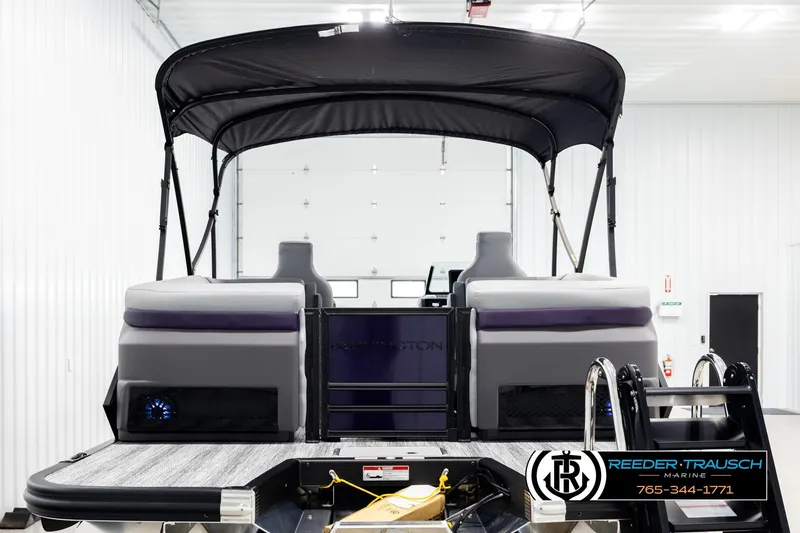 Slide: The Image of 2026 Bennington 22 MFBSE pontoon boat with canopy in showroom, rear view. - 7