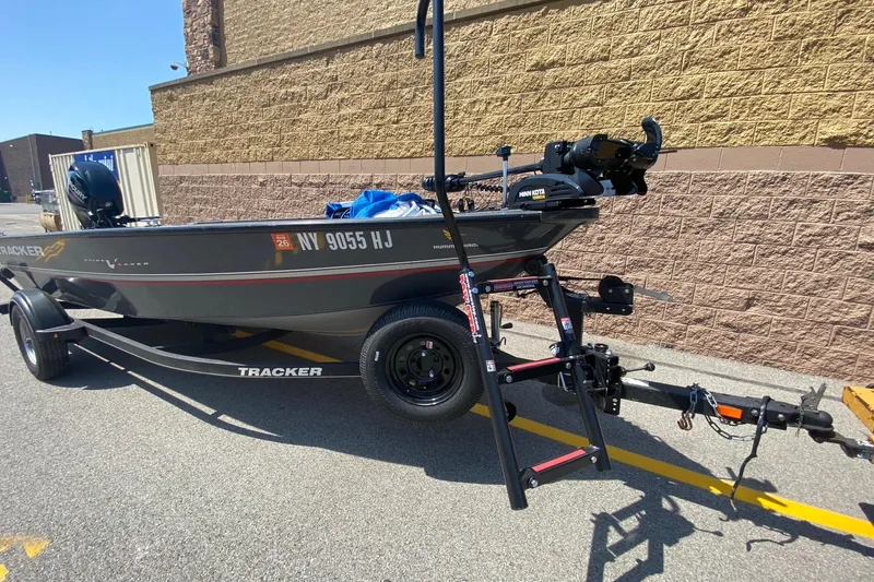 Slide: The Image of 2017 Tracker Guide V-16 Laker DLX T boat on trailer, parked outdoors. - 3