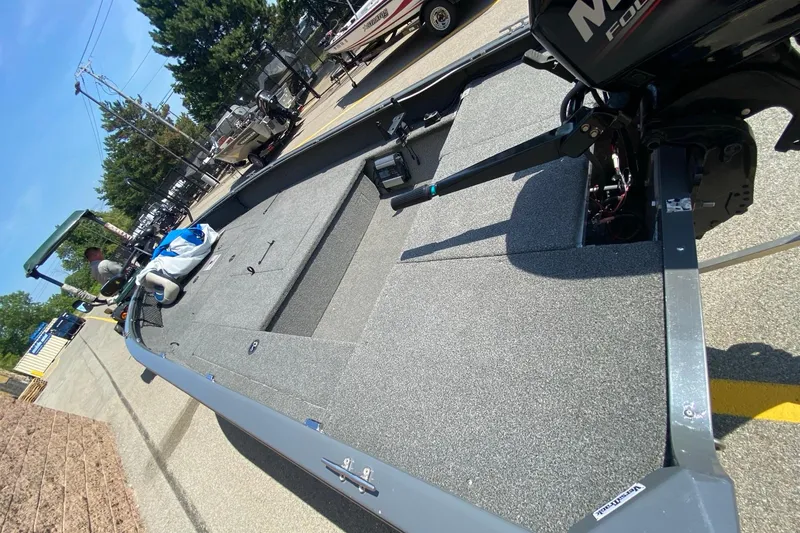 Slide: The Image of 2017 Tracker Guide V-16 Laker DLX T boat with Mercury motor, parked outdoors. - 4