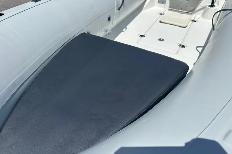 Slide: The Image of 2025 Geniuss 285 TILLER boat interior with cushioned seating and sleek design. - 4