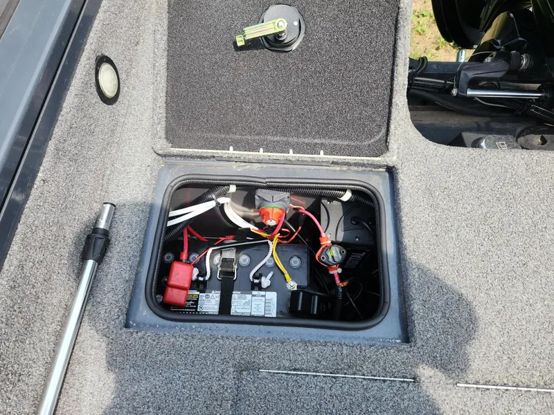 Slide: The Image of 2019 Tracker Targa V-18 Combo boat battery compartment with wiring and components. - 11