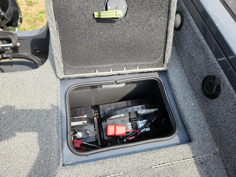 Slide: The Image of 2019 Tracker Targa V-18 Combo boat battery compartment with open hatch. - 12
