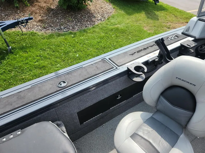 Slide: The Image of 2019 Tracker Targa V-18 Combo boat interior with seating and rod holders. - 19