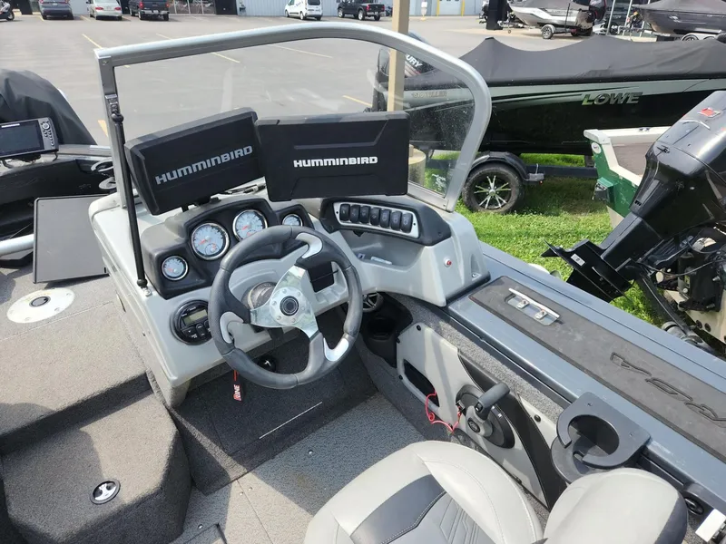 Slide: The Image of 2019 Tracker Targa V-18 Combo boat dashboard with steering wheel and Humminbird displays. - 23