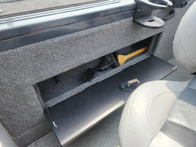 Slide: The Image of 2019 Tracker Targa V-18 Combo boat interior storage compartment with tools and accessories. - 24