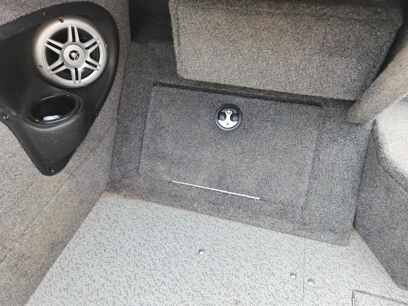 Slide: The Image of 2019 Tracker Targa V-18 Combo interior with speaker and storage compartment. - 28