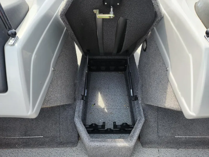 Slide: The Image of 2019 Tracker Targa V-18 Combo boat storage compartment, open and empty, with gray interior. - 31