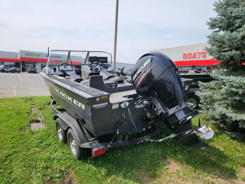Slide: The Image of 2019 Tracker Targa V-18 Combo boat with Mercury engine, parked near dealership. - 4
