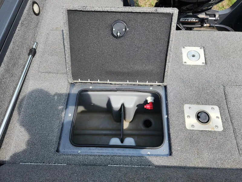 Slide: The Image of Open storage compartment on 2019 Tracker Targa V-18 Combo boat deck. - 9