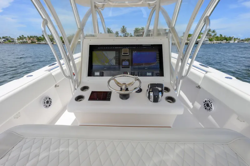 Slide: The Image of 2018 SeaHunter 33 Tournament boat dashboard with navigation screens and steering wheel. - 11