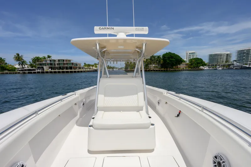 Slide: The Image of 2018 SeaHunter 33 Tournament boat on calm water, featuring a Garmin navigation system. - 12