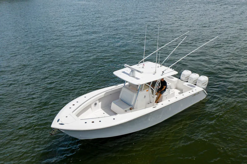 Slide: The Image of 2018 SeaHunter 33 Tournament boat on water, featuring triple outboard engines. - 2