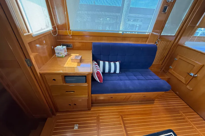 Slide: The Image of Interior of 2002 Grand Banks 42 Classic yacht with blue seating and wooden cabinetry. - 10