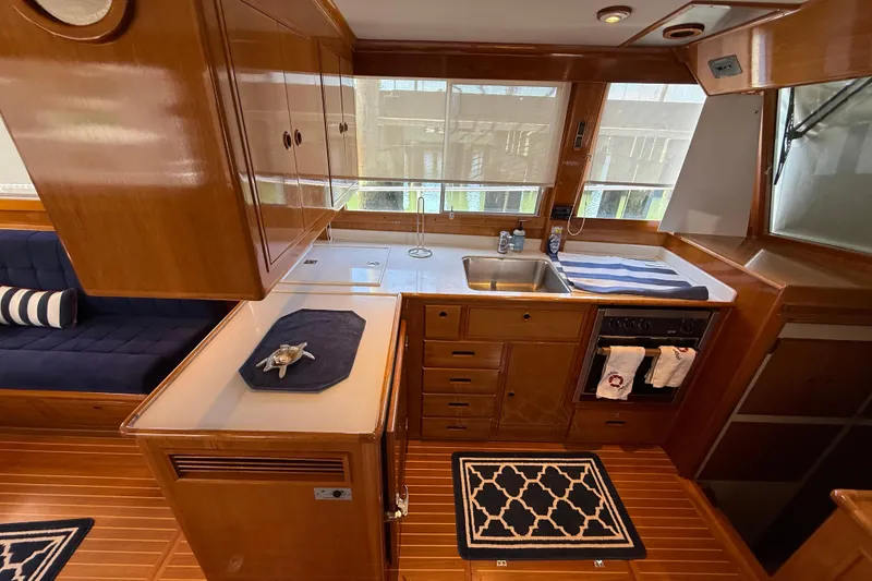 Slide: The Image of Interior of 2002 Grand Banks 42 Classic yacht with wooden cabinetry and modern kitchen amenities. - 12
