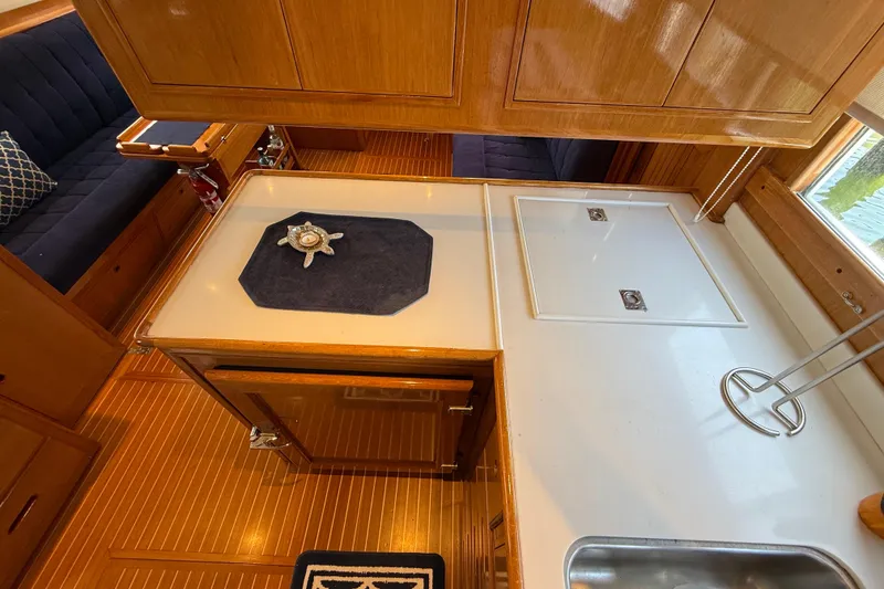 Slide: The Image of Interior of 2002 Grand Banks 42 Classic yacht with wooden cabinetry and seating. - 16