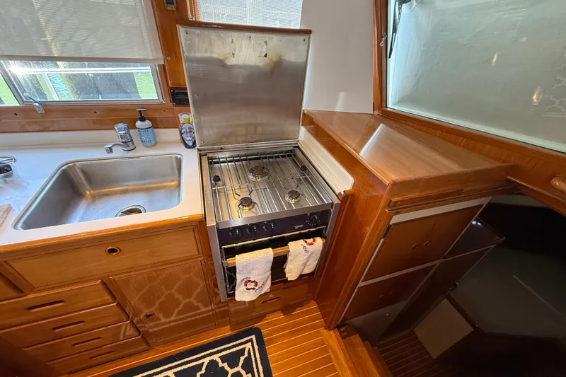 Slide: The Image of Galley kitchen in 2002 Grand Banks 42 Classic yacht with stove and sink. - 17
