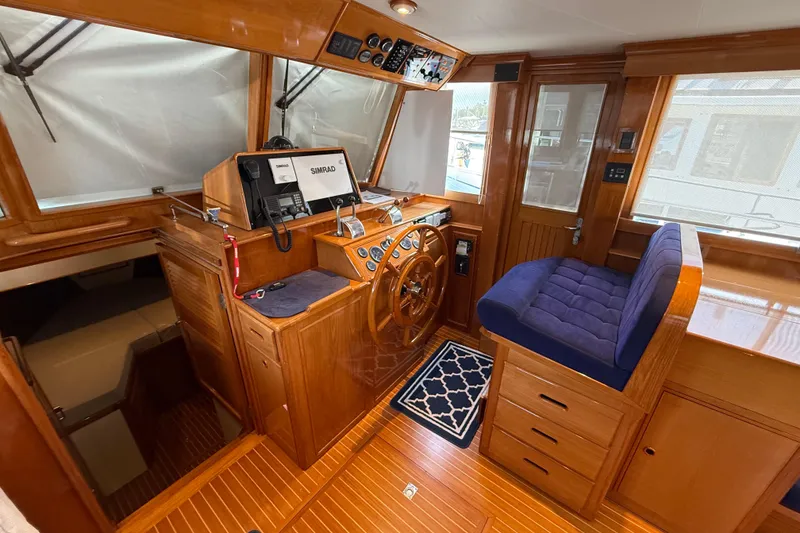 Slide: The Image of Helm of 2002 Grand Banks 42 Classic yacht with wooden finish and navigation equipment. - 19