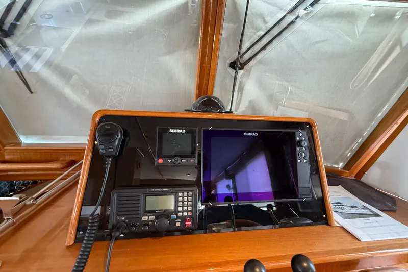 Slide: The Image of Navigation equipment on 2002 Grand Banks 42 Classic yacht dashboard with Simrad displays. - 20