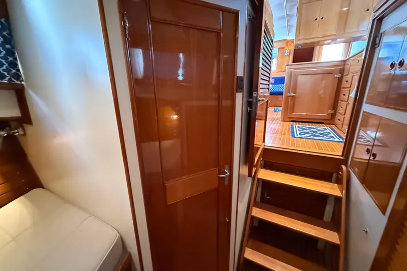Slide: The Image of Interior of 2002 Grand Banks 42 Classic yacht, featuring wooden cabinetry and stairs. - 28