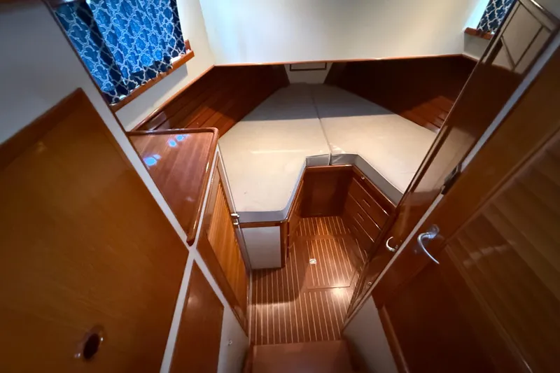 Slide: The Image of Interior cabin of 2002 Grand Banks 42 Classic yacht with wood finish and bed. - 29