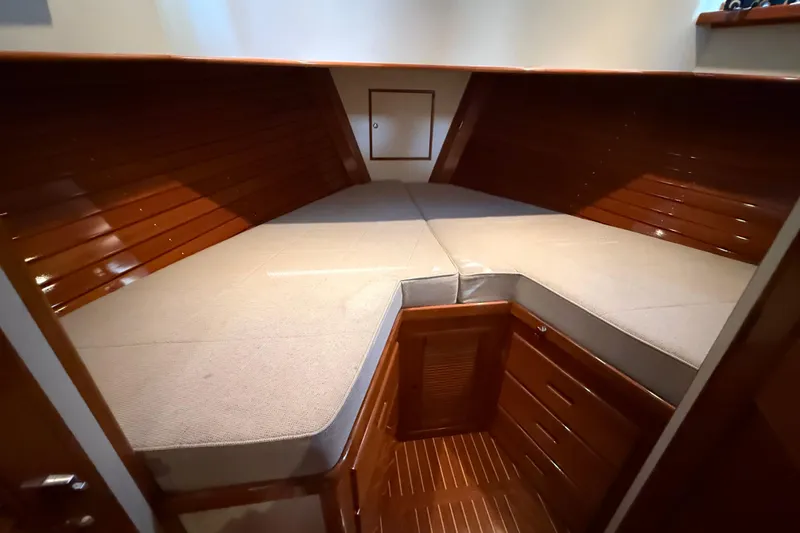Slide: The Image of Cozy cabin interior of 2002 Grand Banks 42 Classic yacht with wooden finish and cushioned seating. - 31