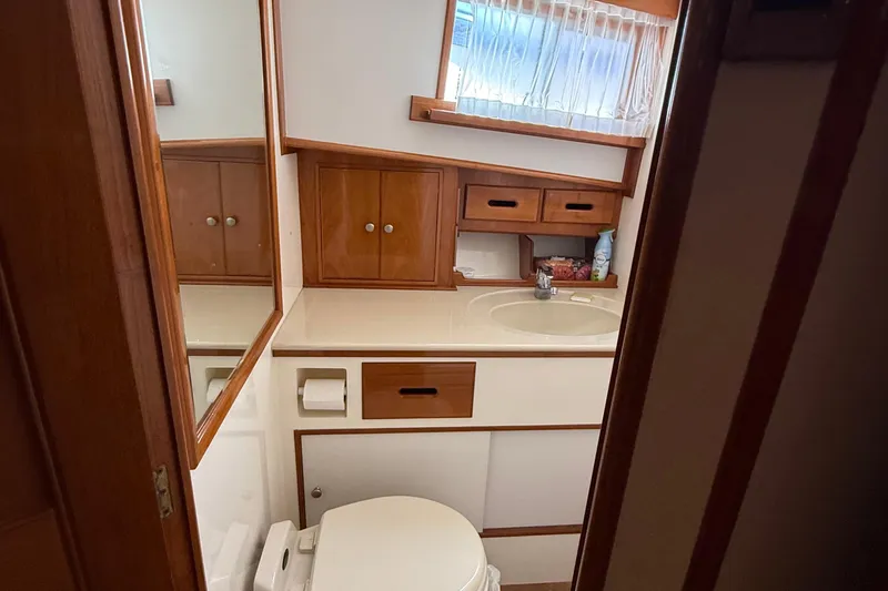 Slide: The Image of Bathroom interior of 2002 Grand Banks 42 Classic yacht, featuring wooden cabinetry and sink. - 33