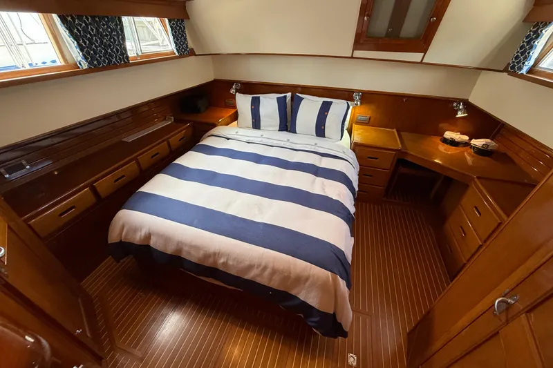Slide: The Image of Luxurious cabin interior of 2002 Grand Banks 42 Classic yacht with striped bedding. - 36