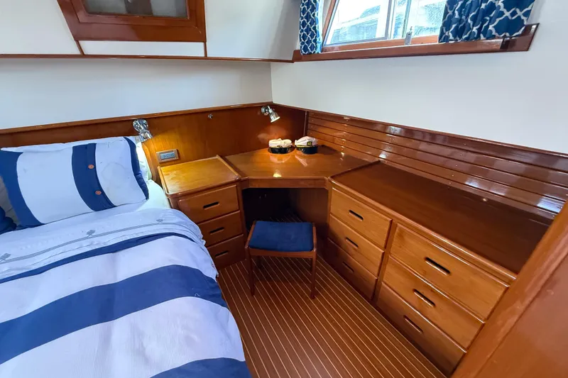 Slide: The Image of Luxurious cabin interior of 2002 Grand Banks 42 Classic yacht with wood finish and cozy bedding. - 38