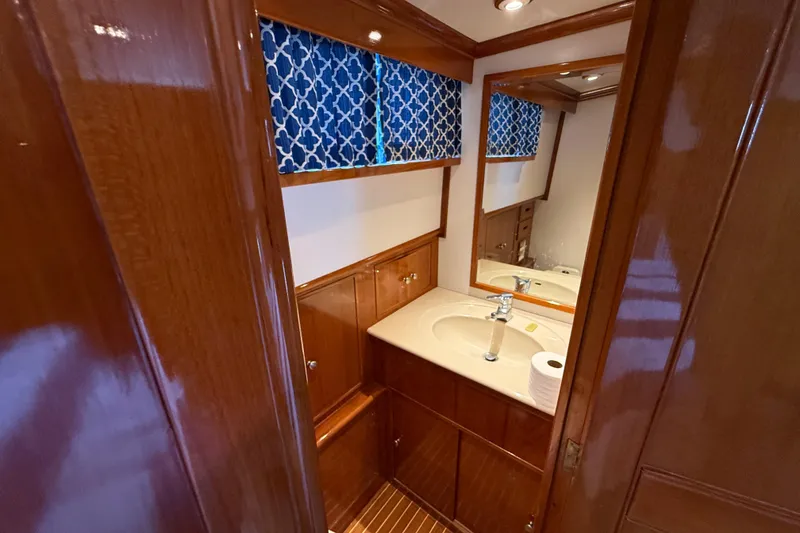 Slide: The Image of Luxurious bathroom interior of 2002 Grand Banks 42 Classic yacht with wooden cabinetry. - 40