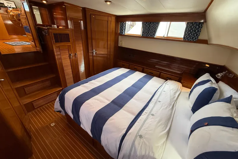 Slide: The Image of Luxurious cabin interior of 2002 Grand Banks 42 Classic yacht with striped bedding. - 45